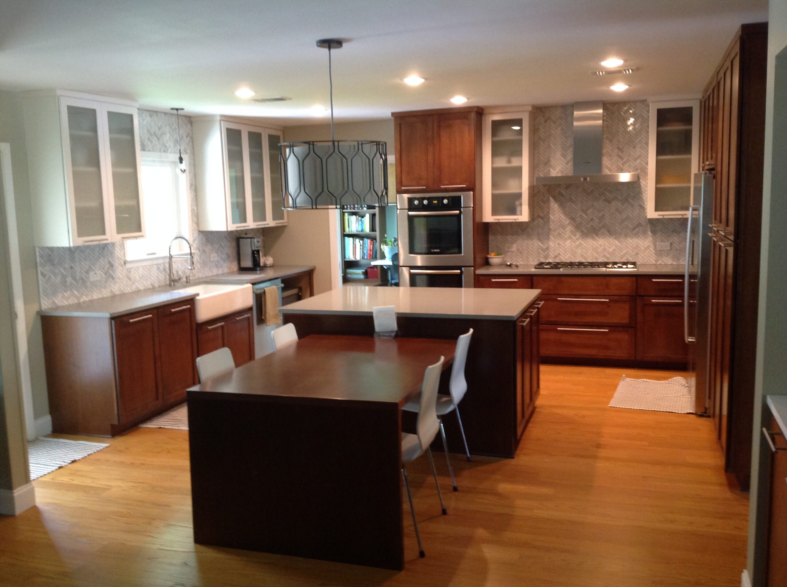 Cabinet specialist measuring kitchen walls and planning precise custom cabinet installation