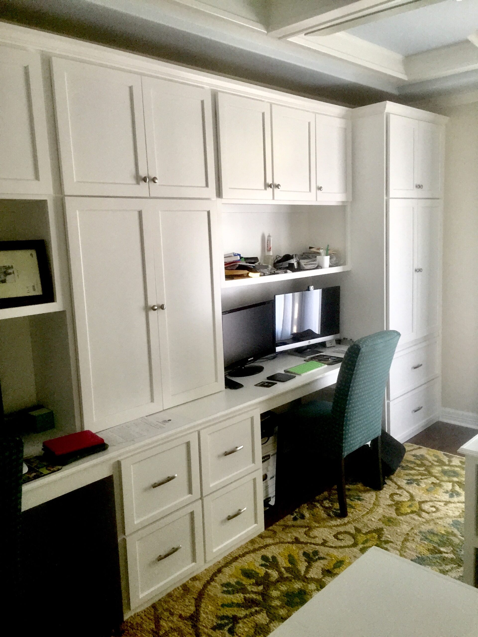 Cabinet craftsman installing a precise custom entertainment center with concealed media wiring