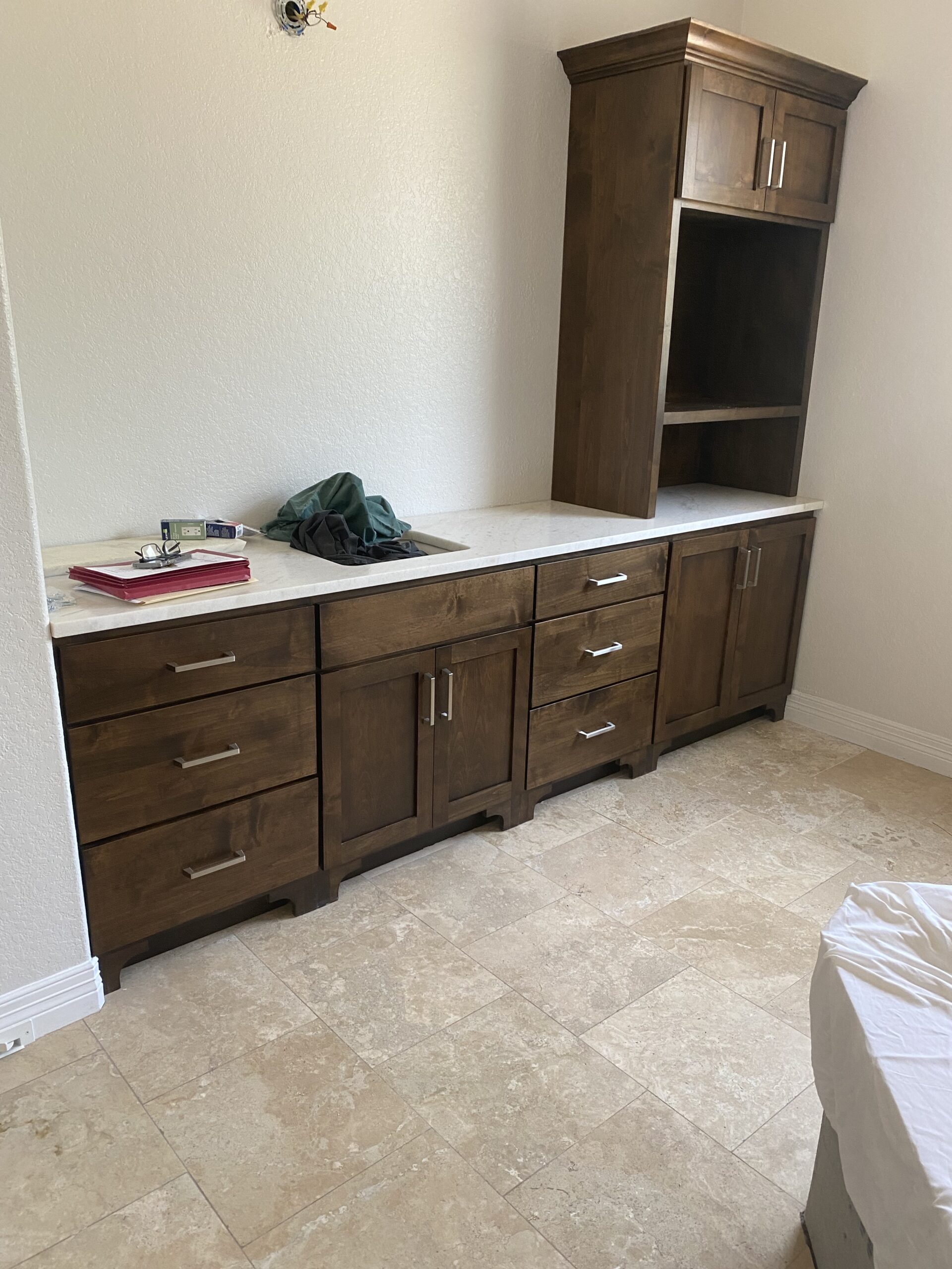 Elegant bathroom vanity cabinets installed beside a bright mirror in a remodeled home